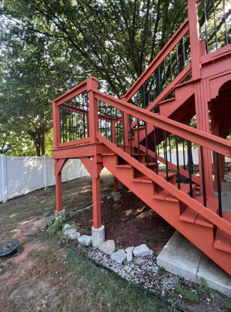Large deck with stairs and spindles.